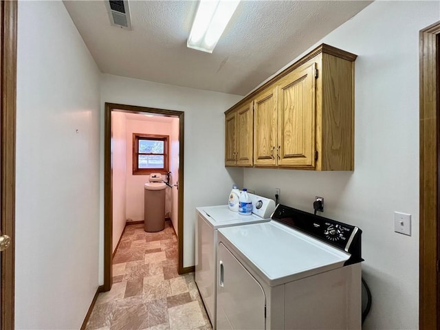 31 Table Rock Dr, Holiday Island, AR 72631 - laundry room with cabinet space, stone finish floors, and separate washer and dryer