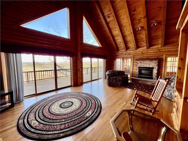 31 Table Rock Dr, Holiday Island, AR 72631 - living room featuring high vaulted ceiling, a wood ceiling with exposed beams, plenty of natural light, wood finished floors, and a fireplace