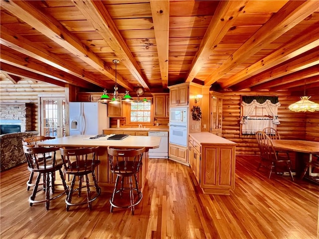 31 Table Rock Dr, Holiday Island, AR 72631 - kitchen featuring white appliances, rustic walls, light countertops, light wood-type flooring, and a center island