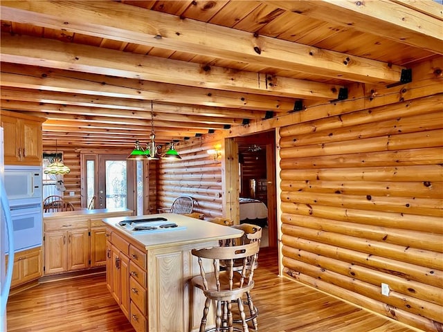 31 Table Rock Dr, Holiday Island, AR 72631 - kitchen with light wood finished floors, rustic walls, electric cooktop, a wooden ceiling with exposed beams, and a breakfast bar area