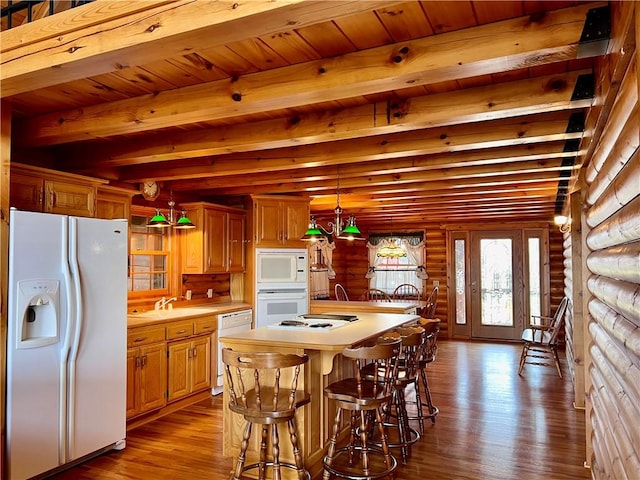 31 Table Rock Dr, Holiday Island, AR 72631 - kitchen featuring white appliances, dark wood finished floors, rustic walls, light countertops, and a wooden ceiling with exposed beams