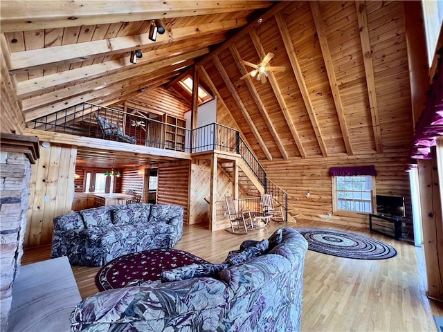 31 Table Rock Dr, Holiday Island, AR 72631 - living room featuring a wood ceiling with exposed beams, high vaulted ceiling, hardwood / wood-style flooring, rail lighting, and stairway