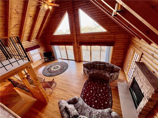 31 Table Rock Dr, Holiday Island, AR 72631 - living area with a fireplace, high vaulted ceiling, log walls, a wooden ceiling with exposed beams, and plenty of natural light