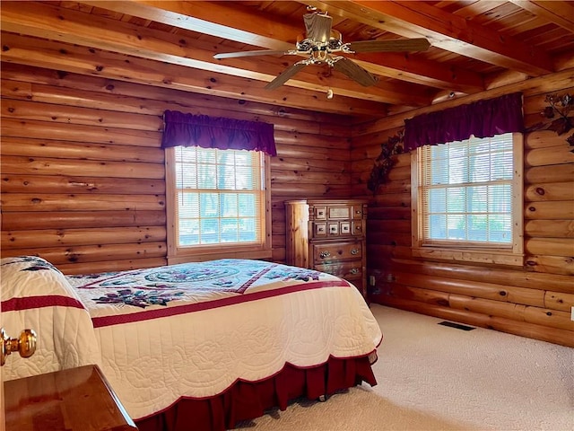 31 Table Rock Dr, Holiday Island, AR 72631 - bedroom with a wood ceiling with exposed beams, carpet floors, multiple windows, and rustic walls