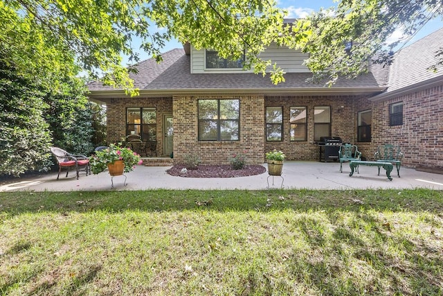 4130 Willowbend Dr, Rogers, AR 72758 - back of house featuring a lawn, a patio area, and brick siding