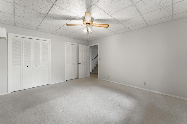 8394 Admiral Nimitz Dr, Rogers, AR 72756 - unfurnished bedroom featuring two closets, a drop ceiling, and a ceiling fan
