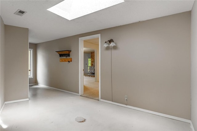 8394 Admiral Nimitz Dr, Rogers, AR 72756 - spare room with a skylight and finished concrete floors