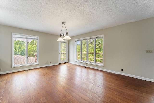 8394 Admiral Nimitz Dr, Rogers, AR 72756 - spare room featuring hardwood / wood-style floors and a textured ceiling