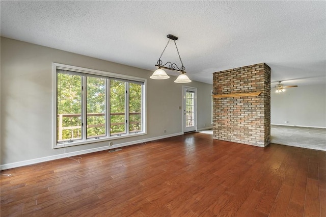 8394 Admiral Nimitz Dr, Rogers, AR 72756 - unfurnished living room featuring wood finished floors, ceiling fan, and a textured ceiling