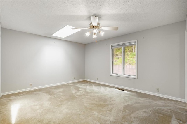 8394 Admiral Nimitz Dr, Rogers, AR 72756 - spare room with ceiling fan, carpet, a skylight, and a textured ceiling