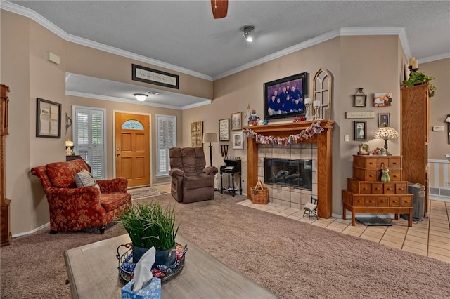 2105 Brookhaven Dr, Alma, AR 72921 - living area featuring a tiled fireplace, carpet flooring, crown molding, ceiling fan, and a textured ceiling
