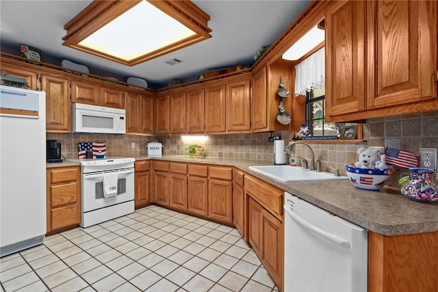 2105 Brookhaven Dr, Alma, AR 72921 - kitchen featuring white appliances, decorative backsplash, and brown cabinets