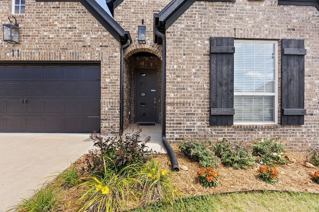 1428 Allens Mill Way, Cave Springs, AR 72718 - property entrance with an attached garage, driveway, and brick siding