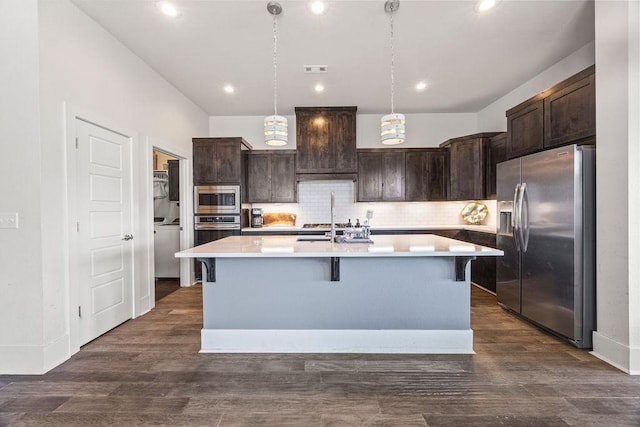 1428 Allens Mill Way, Cave Springs, AR 72718 - kitchen with stainless steel appliances, dark brown cabinets, light countertops, backsplash, and a kitchen island with sink