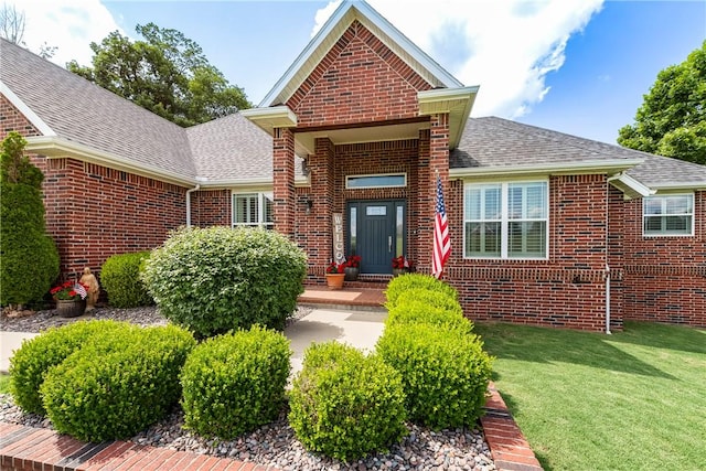 348 Whitcliff Dr, Cave Springs, AR 72718 - view of front facade featuring brick siding, a shingled roof, and a front lawn
