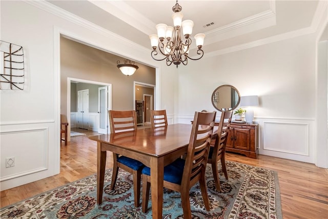 348 Whitcliff Dr, Cave Springs, AR 72718 - dining area with light wood finished floors, a chandelier, ornamental molding, a decorative wall, and a wainscoted wall