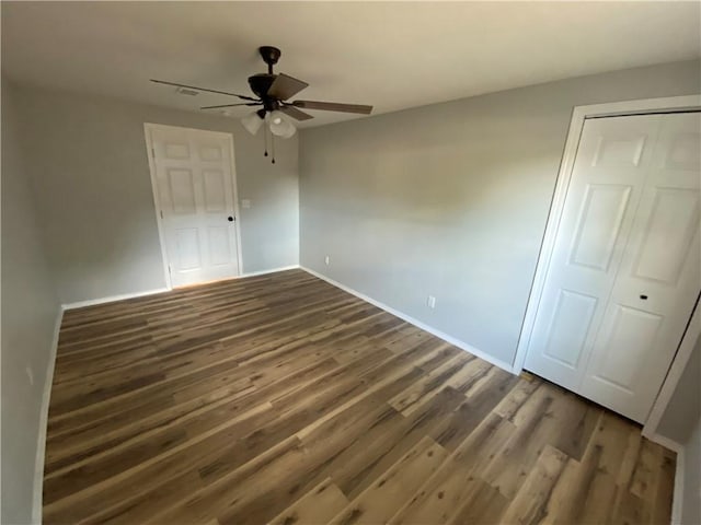 21 S Elizabeth St, Dover, AR 72837 - unfurnished bedroom featuring wood finished floors, a ceiling fan, and a closet