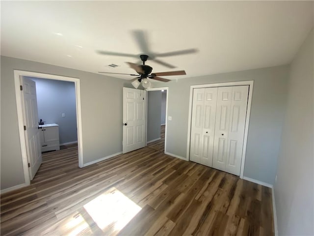 21 S Elizabeth St, Dover, AR 72837 - unfurnished bedroom featuring wood finished floors, a closet, and ceiling fan