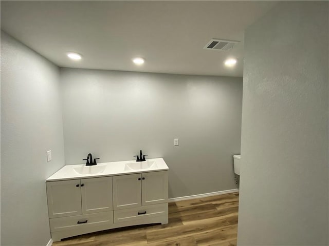 21 S Elizabeth St, Dover, AR 72837 - bathroom with wood finished floors, recessed lighting, and double vanity