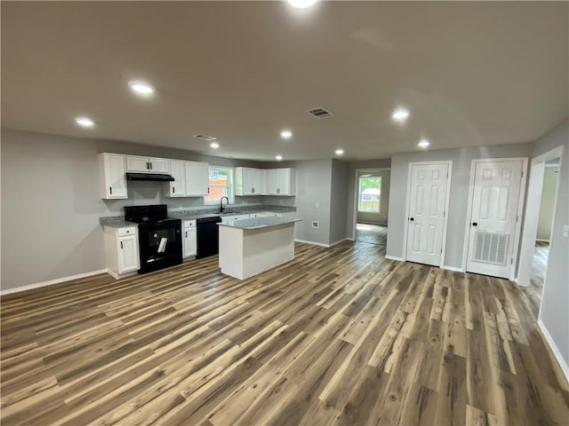21 S Elizabeth St, Dover, AR 72837 - kitchen featuring black appliances, white cabinets, wood finished floors, a kitchen island, and recessed lighting