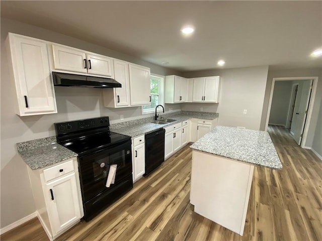21 S Elizabeth St, Dover, AR 72837 - kitchen with black appliances, under cabinet range hood, a kitchen island, light stone counters, and recessed lighting