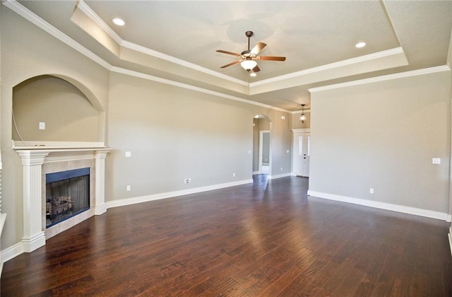 145 Rosemeade Dr, Farmington, AR 72730 - unfurnished living room featuring a raised ceiling, a ceiling fan, arched walkways, dark wood finished floors, and crown molding