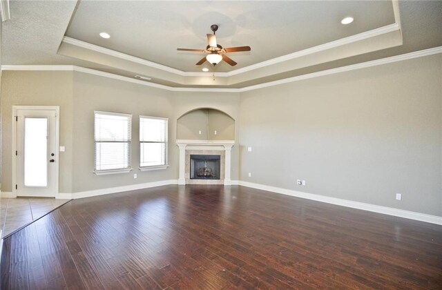 145 Rosemeade Dr, Farmington, AR 72730 - unfurnished living room with a raised ceiling, ceiling fan, crown molding, wood finished floors, and a tile fireplace
