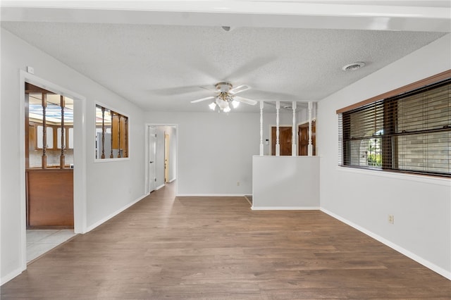 603 Thomas Blvd, Springdale, AR 72762 - unfurnished room featuring wood finished floors, a ceiling fan, and a textured ceiling