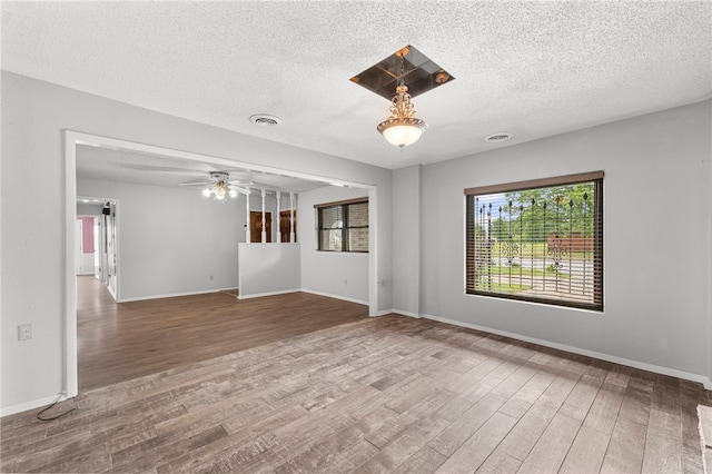 603 Thomas Blvd, Springdale, AR 72762 - empty room featuring wood finished floors, a textured ceiling, and a ceiling fan