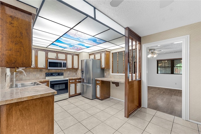603 Thomas Blvd, Springdale, AR 72762 - kitchen featuring white electric range, stainless steel fridge with ice dispenser, ceiling fan, backsplash, and light countertops