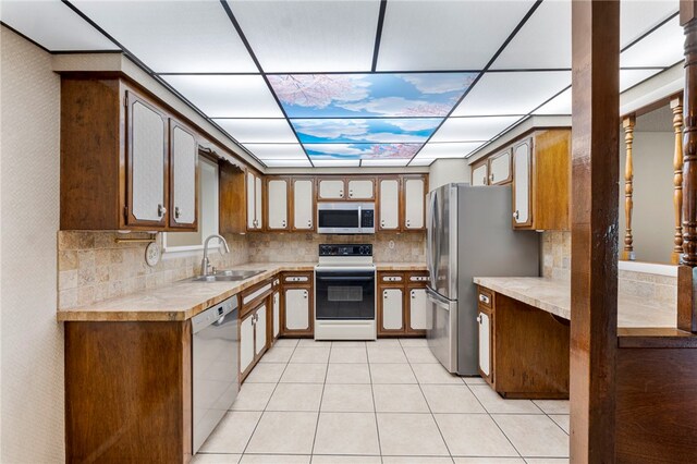 603 Thomas Blvd, Springdale, AR 72762 - kitchen featuring appliances with stainless steel finishes, light countertops, light tile patterned flooring, and backsplash