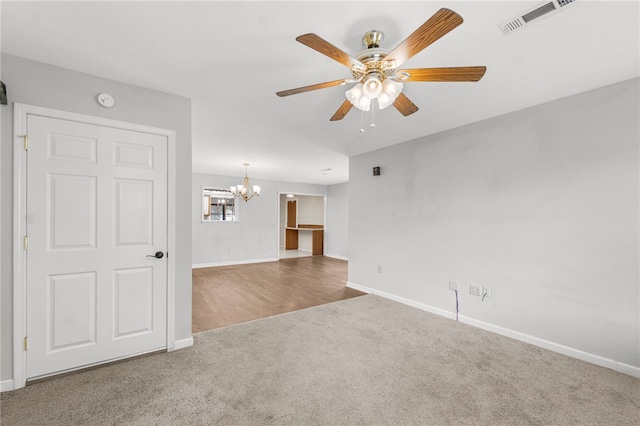 603 Thomas Blvd, Springdale, AR 72762 - spare room featuring carpet flooring, a chandelier, a ceiling fan, and a smoke detector