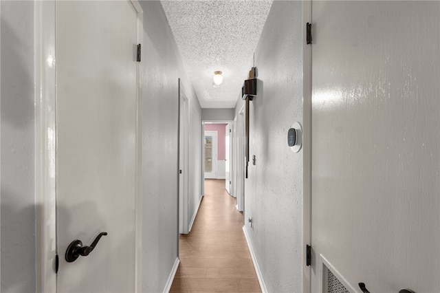 603 Thomas Blvd, Springdale, AR 72762 - hall with a textured ceiling and wood finished floors