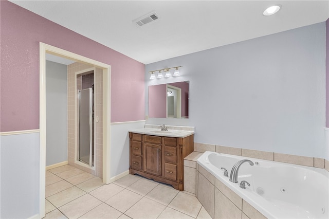 603 Thomas Blvd, Springdale, AR 72762 - bathroom featuring vanity, a jetted tub, tile patterned floors, and a stall shower