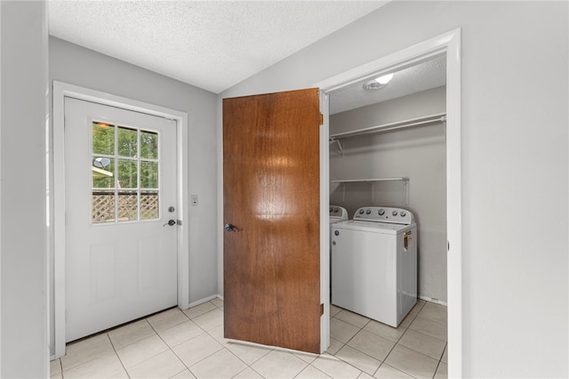 603 Thomas Blvd, Springdale, AR 72762 - laundry room with a textured ceiling, washing machine and clothes dryer, and light tile patterned flooring