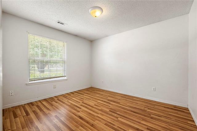 3103 Levi Ln, Bentonville, AR 72712 - unfurnished room featuring light wood finished floors and a textured ceiling