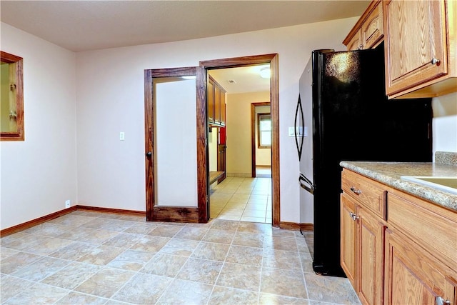 19135 Shoreline Way, Fayetteville, AR 72703 - kitchen featuring light countertops, brown cabinets, and freestanding refrigerator