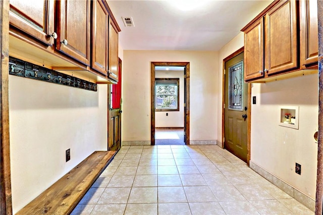 19135 Shoreline Way, Fayetteville, AR 72703 - washroom featuring cabinet space, hookup for a washing machine, and light tile patterned floors