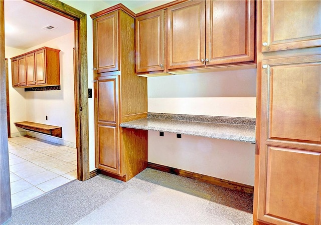19135 Shoreline Way, Fayetteville, AR 72703 - kitchen featuring built in study area and brown cabinets