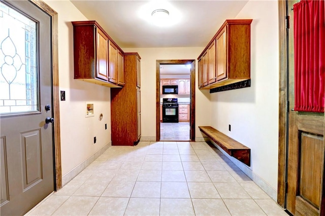 19135 Shoreline Way, Fayetteville, AR 72703 - washroom with washer hookup, cabinet space, and light tile patterned flooring
