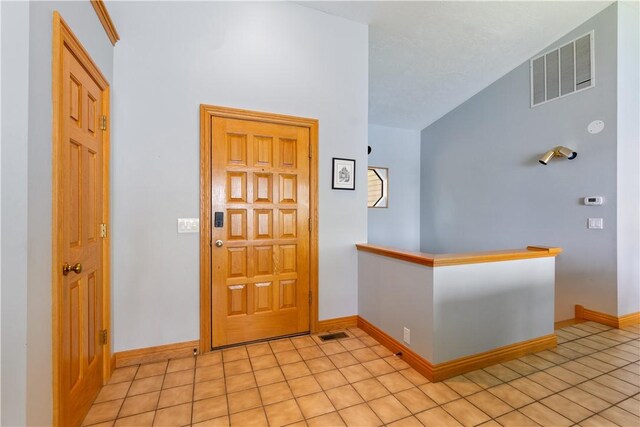 188 Point Mirage Rd, Eureka Springs, AR 72631 - foyer entrance with light tile patterned floors and vaulted ceiling