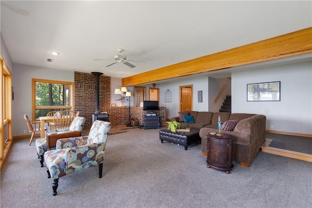 188 Point Mirage Rd, Eureka Springs, AR 72631 - living room featuring a wood stove, carpet, stairway, and a ceiling fan