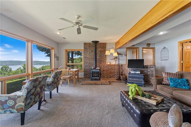 188 Point Mirage Rd, Eureka Springs, AR 72631 - living area featuring a wood stove, carpet floors, ceiling fan, and a water view