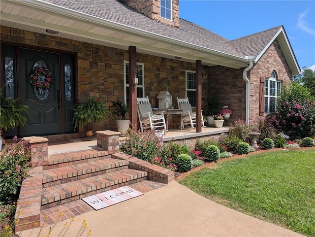 1445 Woodhaven Ln, Harrison, AR 72601 - view of exterior entry with roof with shingles, a porch, a lawn, and stone siding