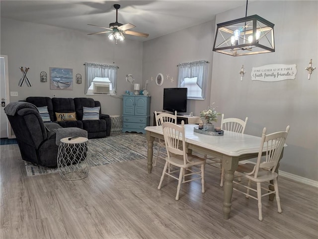 1445 Woodhaven Ln, Harrison, AR 72601 - dining area featuring light wood-style floors, a ceiling fan, and a chandelier