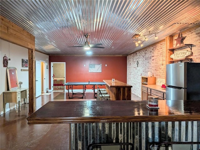 1445 Woodhaven Ln, Harrison, AR 72601 - playroom with ceiling fan, finished concrete flooring, and brick wall