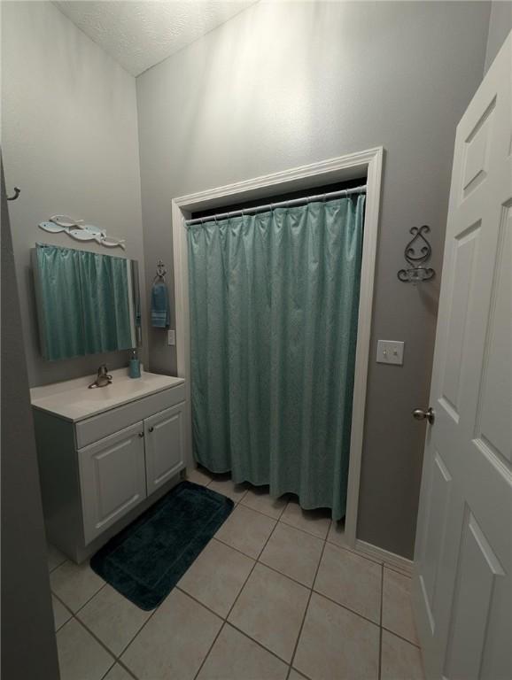1445 Woodhaven Ln, Harrison, AR 72601 - bathroom featuring tile patterned flooring, vanity, and a textured ceiling