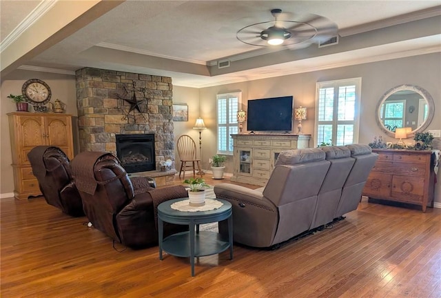 1445 Woodhaven Ln, Harrison, AR 72601 - living room with a stone fireplace, a tray ceiling, ceiling fan, hardwood / wood-style floors, and healthy amount of natural light