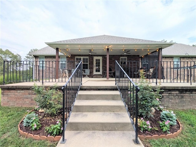 1445 Woodhaven Ln, Harrison, AR 72601 - view of front of house with brick siding, stairway, a ceiling fan, and a shingled roof
