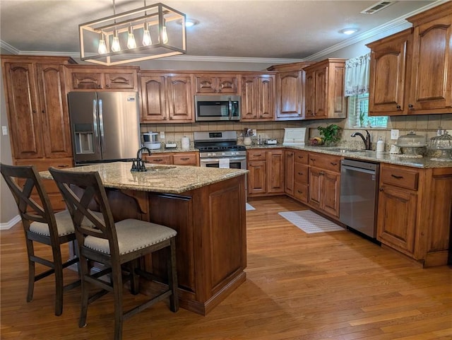 1445 Woodhaven Ln, Harrison, AR 72601 - kitchen with stainless steel appliances, crown molding, light wood-style floors, and backsplash